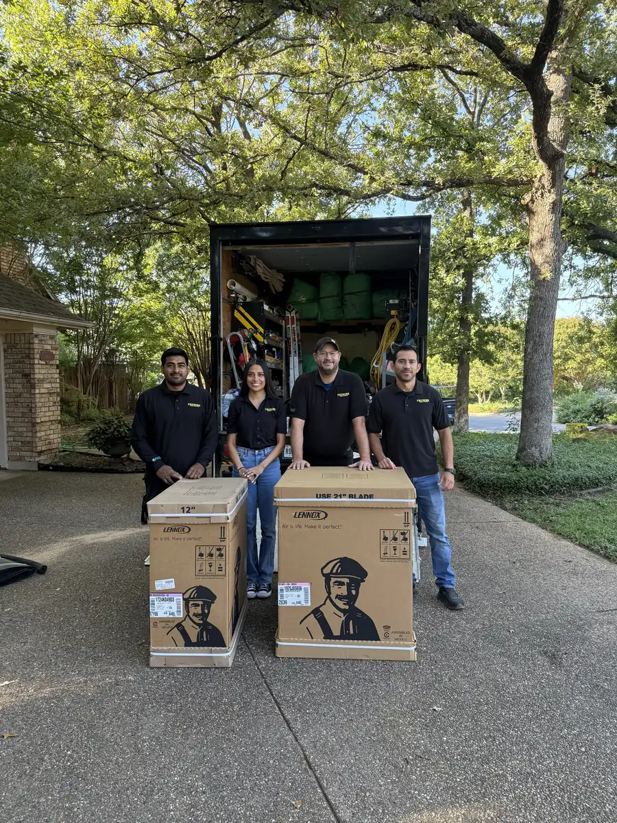 Four Frymire Home Services team members standing with two new Lennox units in front of a Frymire truck