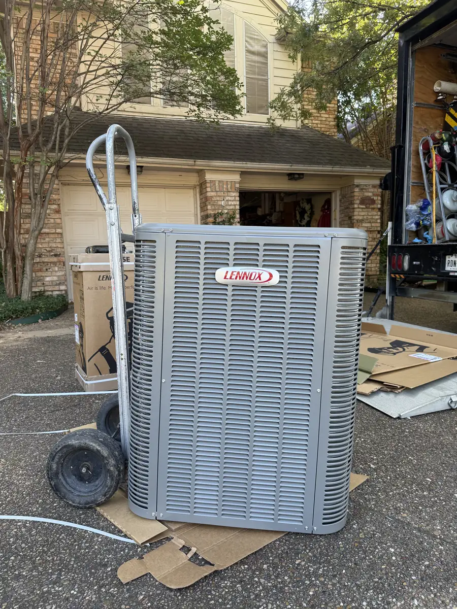 New Lennox air conditioner on a hand truck outside the home before installation
