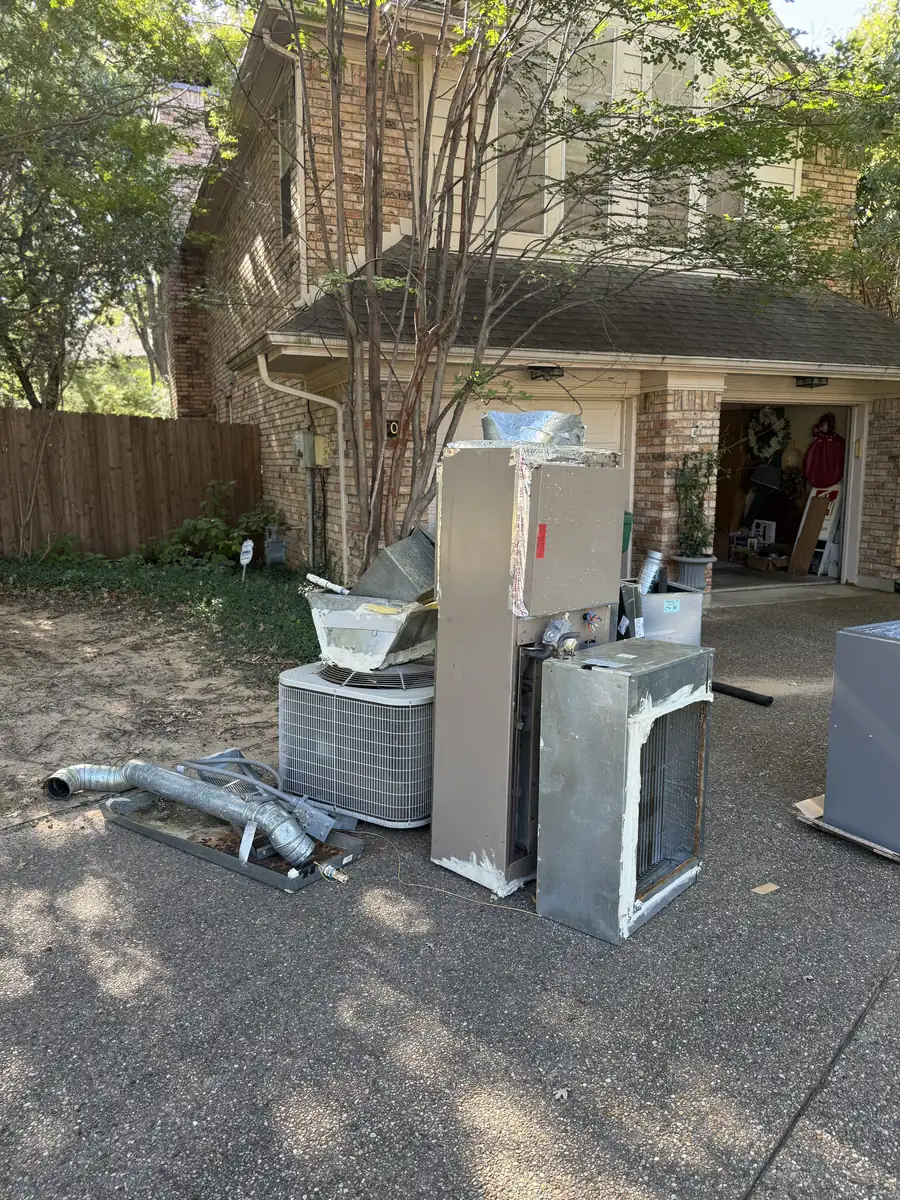 Old furnace, air conditioner and ductwork removed from the home and staged in the driveway