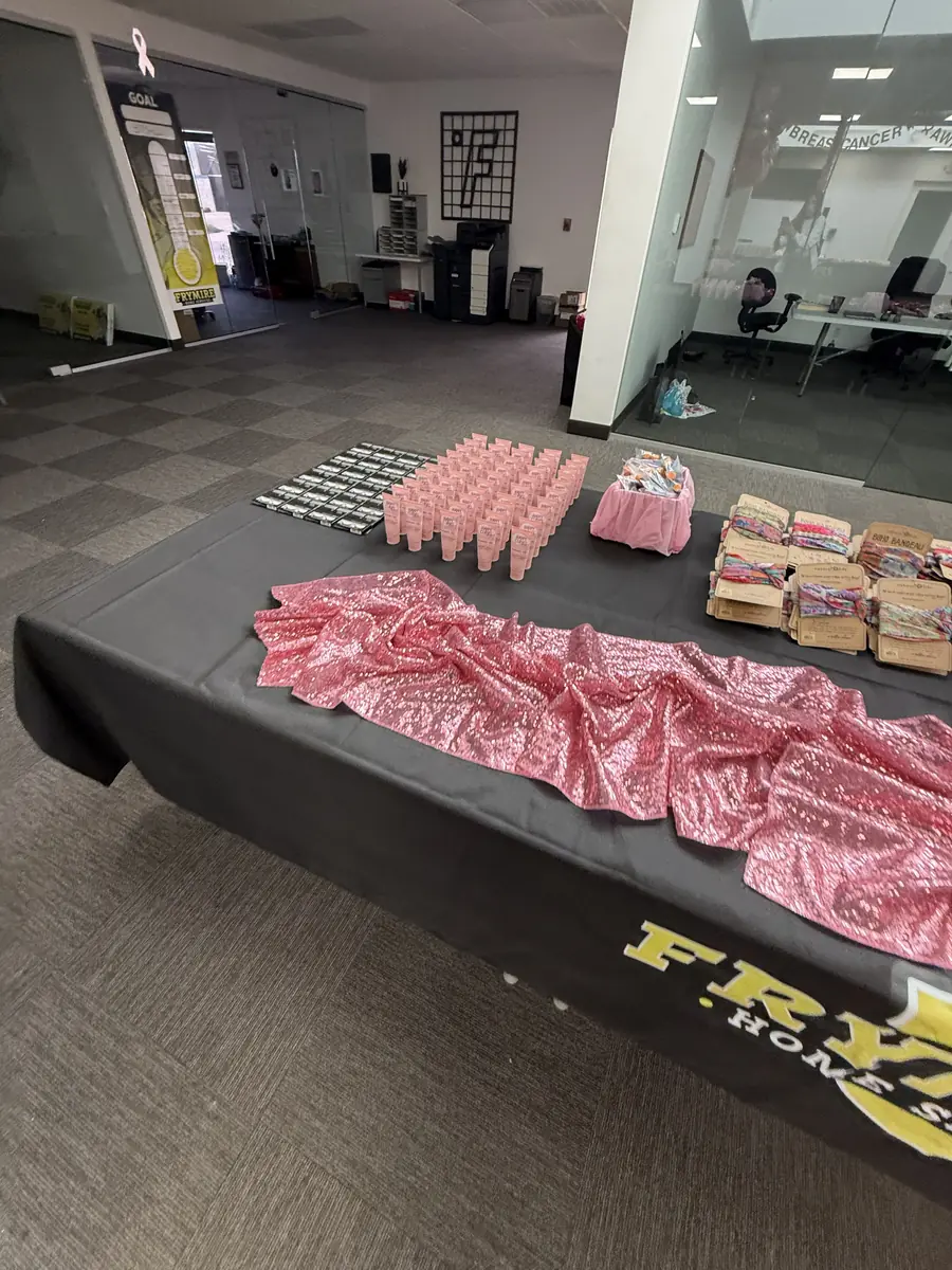 Tables lined with lotions, comfort items and empty boxes ready to be packed into HOPE Kits