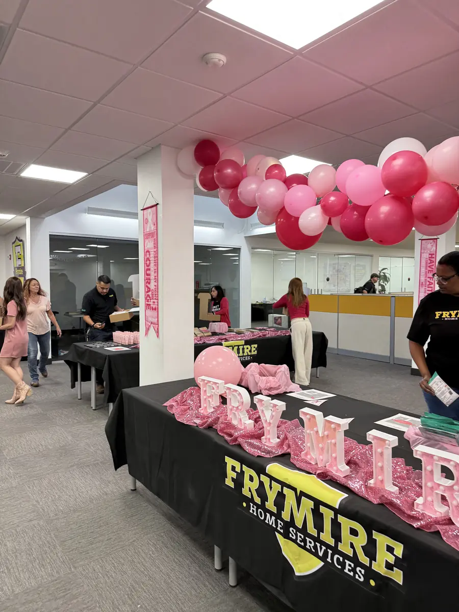 Wide view of the Frymire office during the HOPE Kits packing event with pink balloons overhead