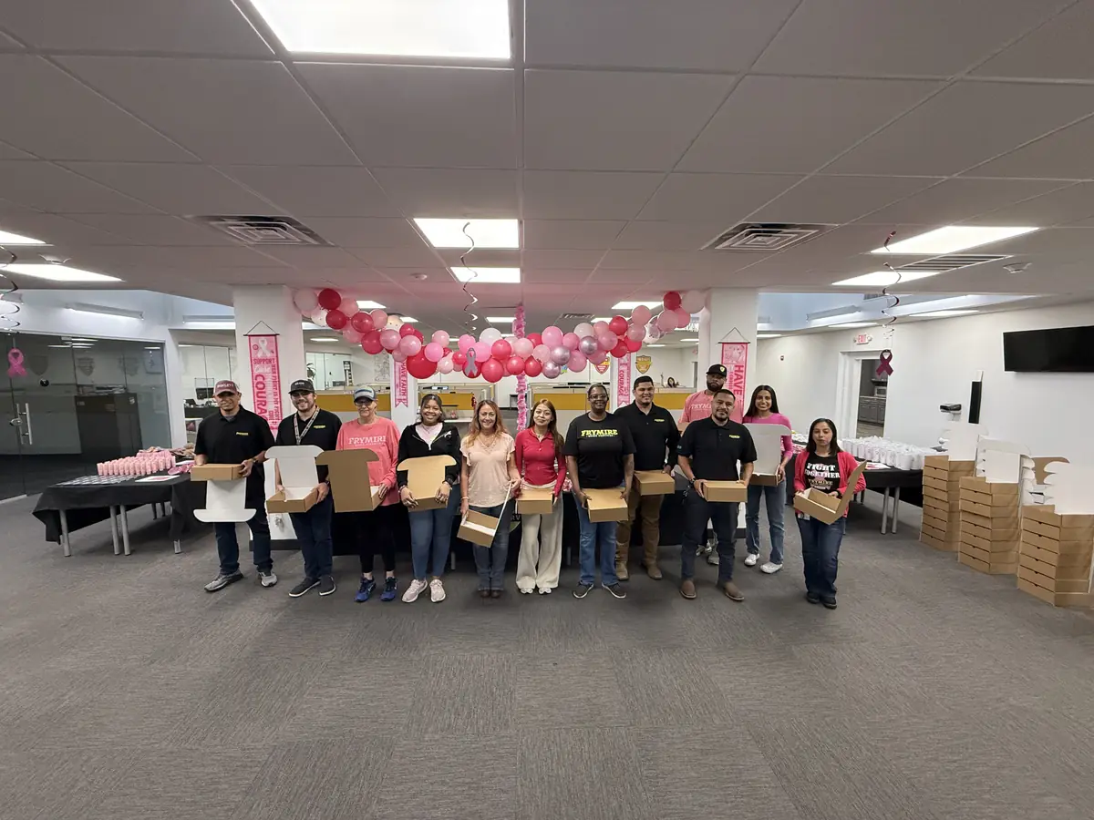 Frymire Home Services team holding finished HOPE Kits in the decorated office