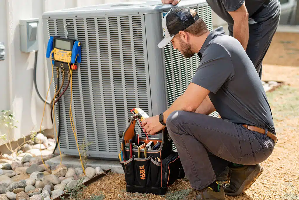 Frymire technician completing water heater repairs in Dallas, TX.