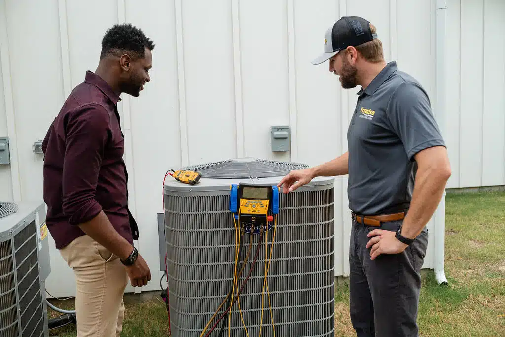 a man standing next to a fence